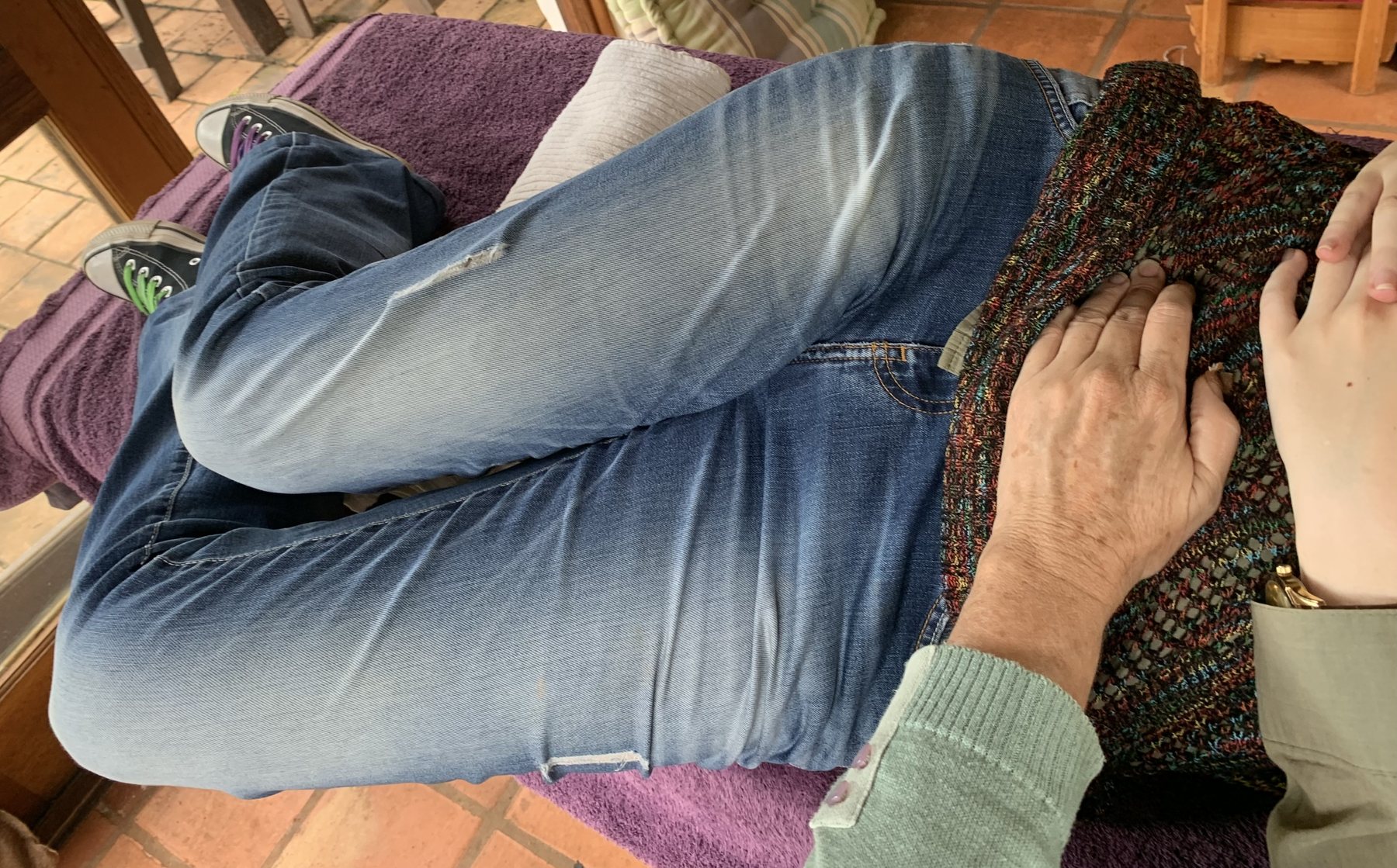 Julia's hands working with an adult client during treatment